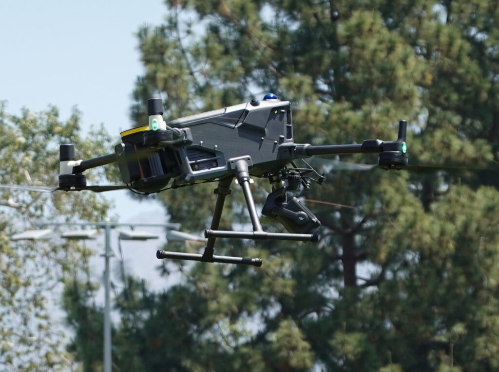 A modern drone flying outdoors showcasing advanced technology and design.